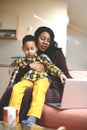 Little boy showing something to his mother on laptop. Royalty Free Stock Photo