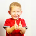 Little boy showing thumb up success hand sign gesture. Royalty Free Stock Photo