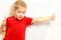 Little boy showing thumb up success hand sign gesture. Royalty Free Stock Photo