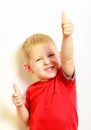 Little boy showing thumb up success hand sign gesture.