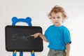Little boy shows Einstein's formula on blackboard Royalty Free Stock Photo