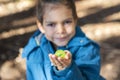 Little boy shows small green ball on his hand