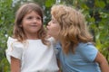 Little boy and shy girl in love. Cheerful kids playing on park outdoors. Summer portrait of happy cute children. Lovely Royalty Free Stock Photo