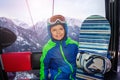 Little boy sit with snowboard in ski lift cabin Royalty Free Stock Photo