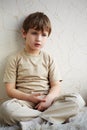 Little boy sits alone on fleecy white rug Royalty Free Stock Photo