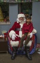 Little boy sits on Santa's lap at Christmas dinner for US Soldiers at Wounded Warrior Center, Camp Pendleton, North of San Diego, Royalty Free Stock Photo