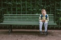 Little Boy Sitting with Apple and Waiting on Rustic Glue Bench Royalty Free Stock Photo