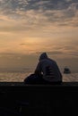 A little boy is sitting on the beach