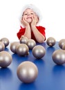 Little boy sitting behind Christmas ornaments Royalty Free Stock Photo