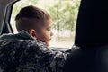Little boy sitting in the car and look out from the car window Royalty Free Stock Photo