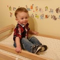 Little boy sitting on a changing table