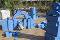 little boy is sitting on childrens playground in park with blue Royalty Free Stock Photo