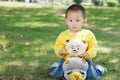 Little boy sitting on the doll