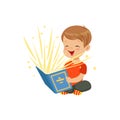 Little boy sitting on the floor with magic book radiating bright sparks and stars. Kid character reading interesting Royalty Free Stock Photo