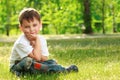 Little boy sitting on grass Royalty Free Stock Photo