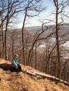 Little boy sitting on a log