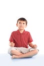 Little boy is sitting in the Lotus position.isolated on white Royalty Free Stock Photo