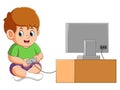 The little boy is sitting and playing the game with the joystick Royalty Free Stock Photo