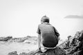 Little boy sitting on the rock on the beach face look happy Royalty Free Stock Photo