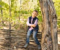 Little boy sitting on a rustic wooden fence Royalty Free Stock Photo