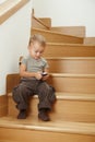 Little boy sitting on stairs Royalty Free Stock Photo