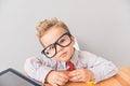 Little boy sitting at table in studio Royalty Free Stock Photo