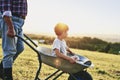 Boy sitting in wheelbarrows at sunset Royalty Free Stock Photo