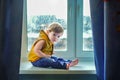 Little boy sitting on the window