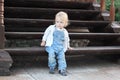 A little boy sitting on wooden stairs Royalty Free Stock Photo