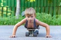 A little boy skates near a house on the road. Royalty Free Stock Photo