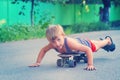 A little boy skates near a house on the road. Royalty Free Stock Photo