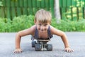 A little boy skates near a house on the road. Royalty Free Stock Photo