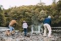 Three Generation Family are Skimming Stones Royalty Free Stock Photo