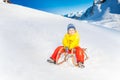 Little boy on the sledge slide down hill Royalty Free Stock Photo