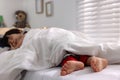 Little boy sleeping in bed at home, focus on feet Royalty Free Stock Photo