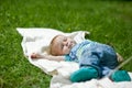 Little boy sleeping on a grass in summer Royalty Free Stock Photo