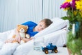 Little boy sleeping in hospital bed with teddy bear Royalty Free Stock Photo