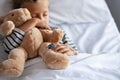 Little boy sleeping in hospital bed with teddy bear Royalty Free Stock Photo