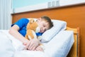 Little boy sleeping in hospital bed with teddy bear Royalty Free Stock Photo