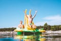 Little boy sliding down into sea water from floating Playground slide Catamaran as she enjoying sea trip with his brother Royalty Free Stock Photo