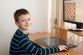 Little boy smile and play online chess Royalty Free Stock Photo