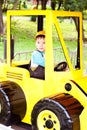 Little boy smiling and playing in the toy car