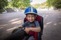 Little boy smiling in the seat bicycle. Kid has biking helmet. Protection on the bicycle. Royalty Free Stock Photo