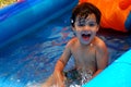 Little boy smiling and splashing in a pool Royalty Free Stock Photo