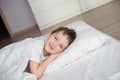 Little boy smiling during waking up in white bed Royalty Free Stock Photo