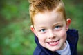 Little boy smiling in the woods Royalty Free Stock Photo