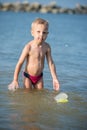 Cute little kid wearing mask and flippers for diving at sand tropical beach. Royalty Free Stock Photo