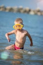 Cute little kid wearing mask and flippers for diving at sand tropical beach. Royalty Free Stock Photo