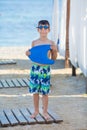 Little boy with snorkel by the sea. Cute little kid wearing mask and flippers for diving at sand tropical beach. Ocean coast Royalty Free Stock Photo