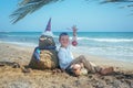 Little boy and Snowmen at tropical ocean beach in santa hat. New Years and Christmas holiday in hot countries concept Royalty Free Stock Photo